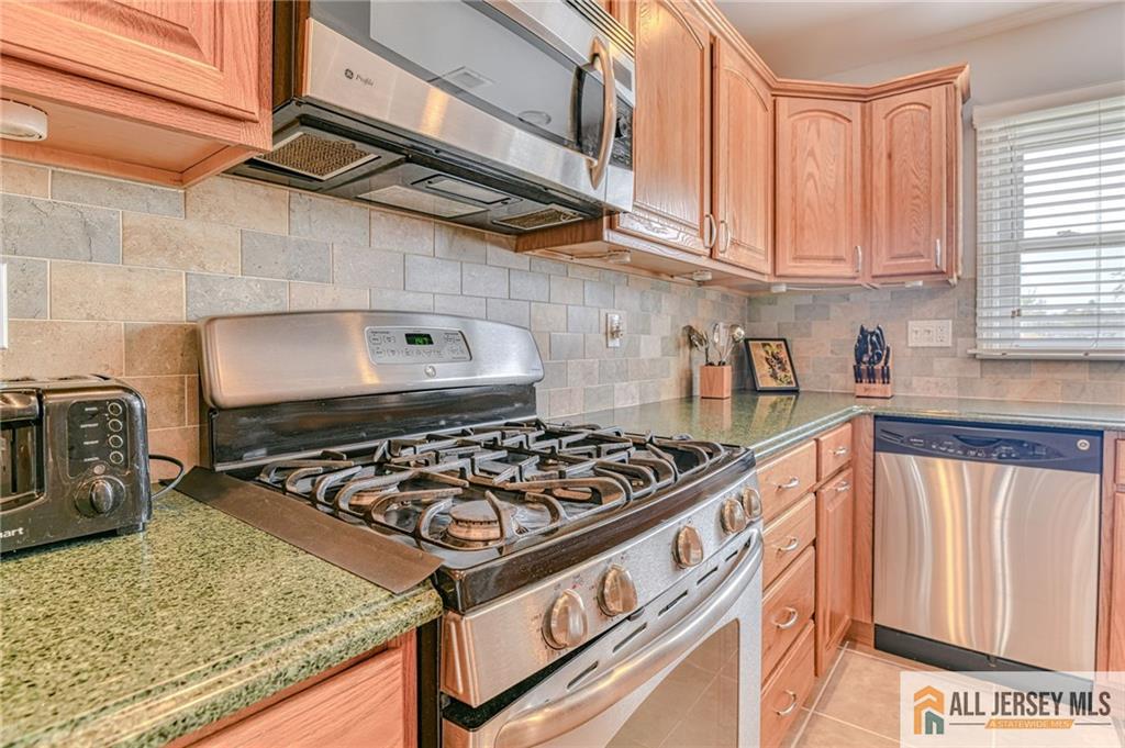 14 Gramercy Road Old Bridge, NJ 08857 - Photo 9 of 26 a kitchen with stainless steel appliances granite countertop a stove and a sink