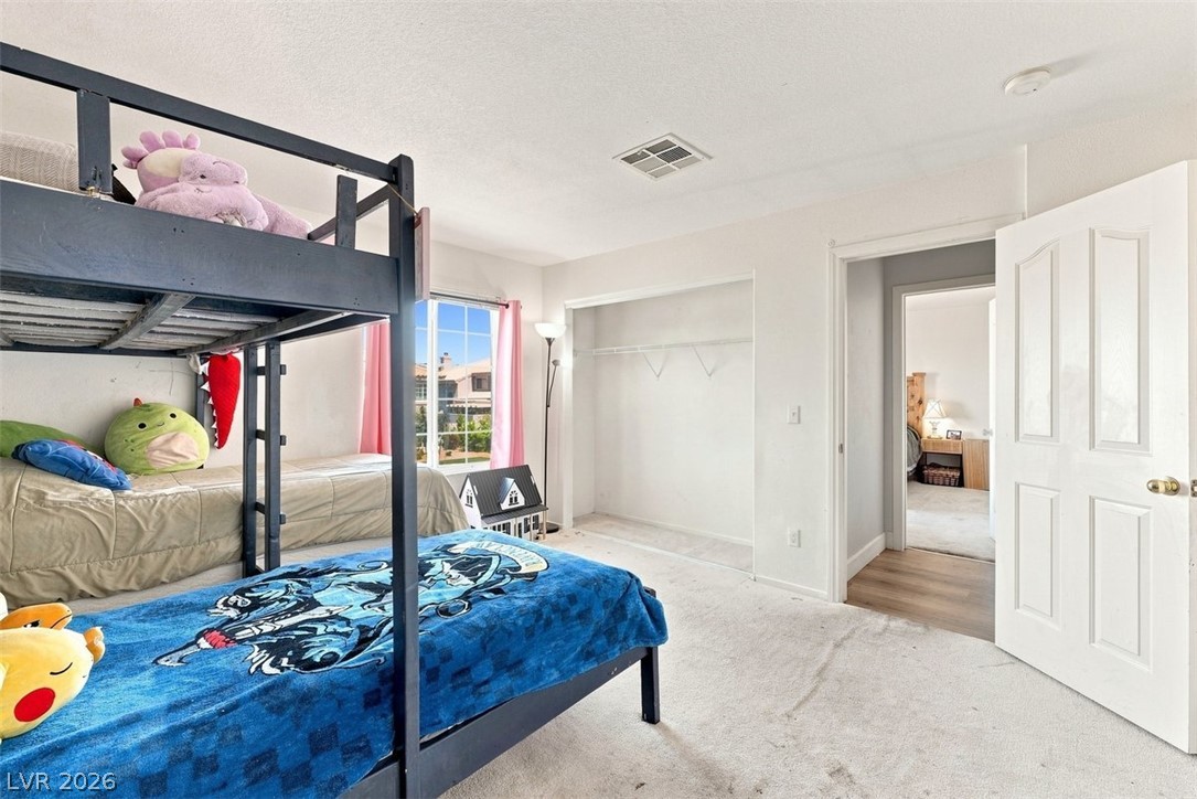 505 Rafkin Place Henderson, NV 89052 - Photo 21 of 35 A well-lit bedroom provides comfortable sleeping arrangements with bunk beds and ample closet space.