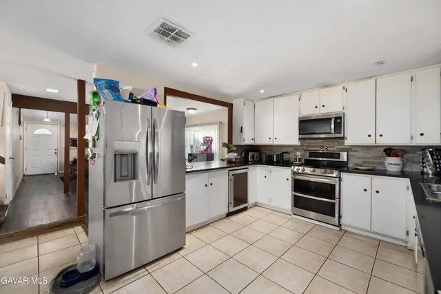 a kitchen with granite countertop cabinets and steel stainless steel appliances