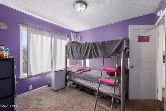 a bedroom with furniture and a chandelier