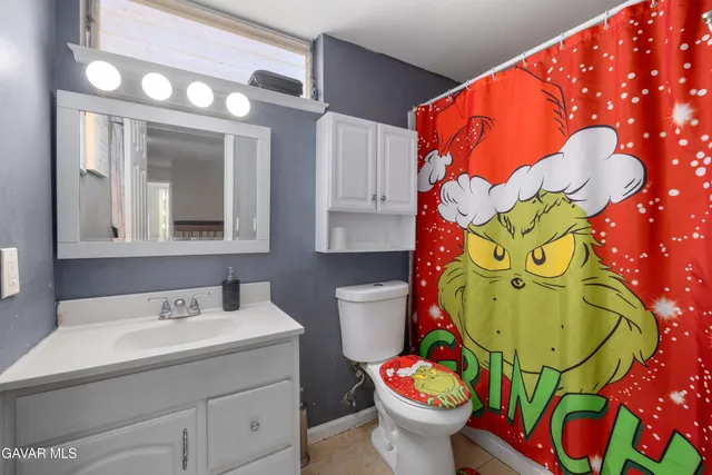 a bathroom with a sink and mirror with toilet