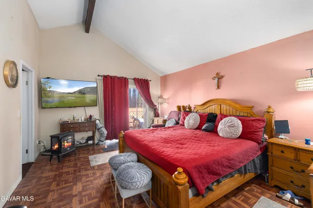 a bedroom with a bed and large window