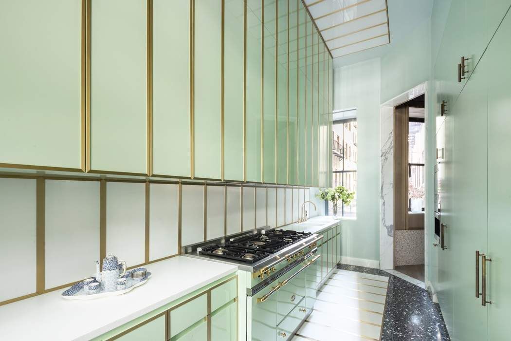 50 Central Park West, Unit MAIS-DUPLEX Manhattan, NY 10023 - Photo 15 of 36 a kitchen with a sink and a stove top oven
