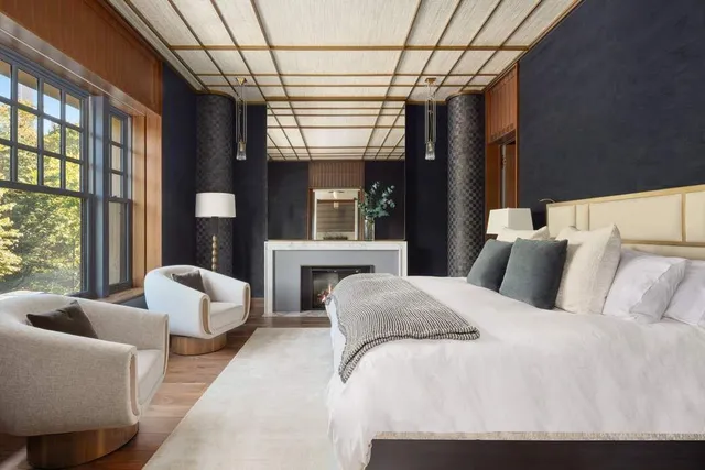 a bedroom with furniture and a large window