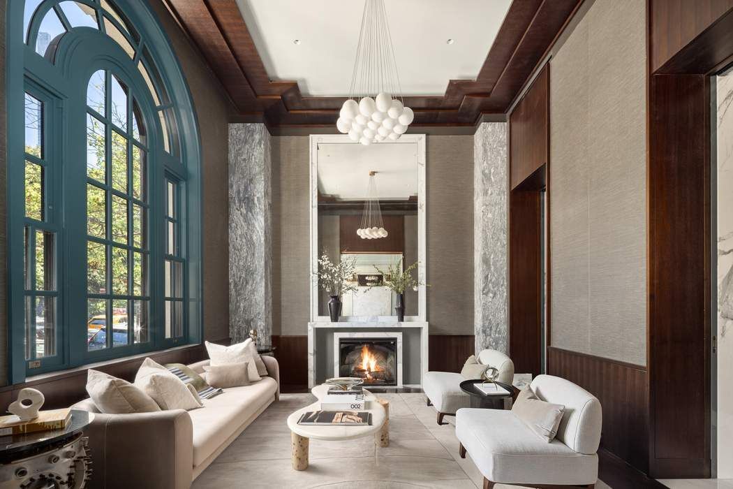 50 Central Park West, Unit MAIS-DUPLEX Manhattan, NY 10023 - Photo 2 of 36 a living room with furniture fireplace and large windows