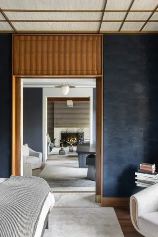 a bedroom with a bed and a fireplace