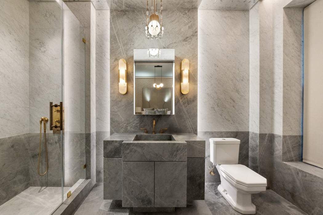 50 Central Park West, Unit MAIS-DUPLEX Manhattan, NY 10023 - Photo 29 of 36 a bathroom with a toilet sink and shower