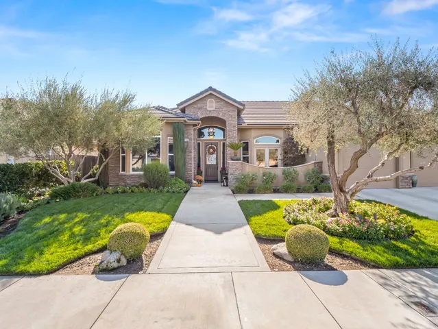 a front view of a house with garden