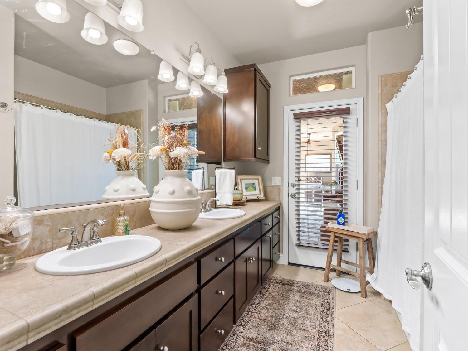 2750 Muncie Avenue Clovis, CA 93619 - Photo 18 of 51 a bathroom with a granite countertop sink a toilet and a mirror