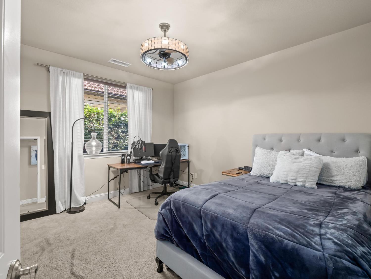 2750 Muncie Avenue Clovis, CA 93619 - Photo 19 of 51 a bedroom with a bed and a table with chair