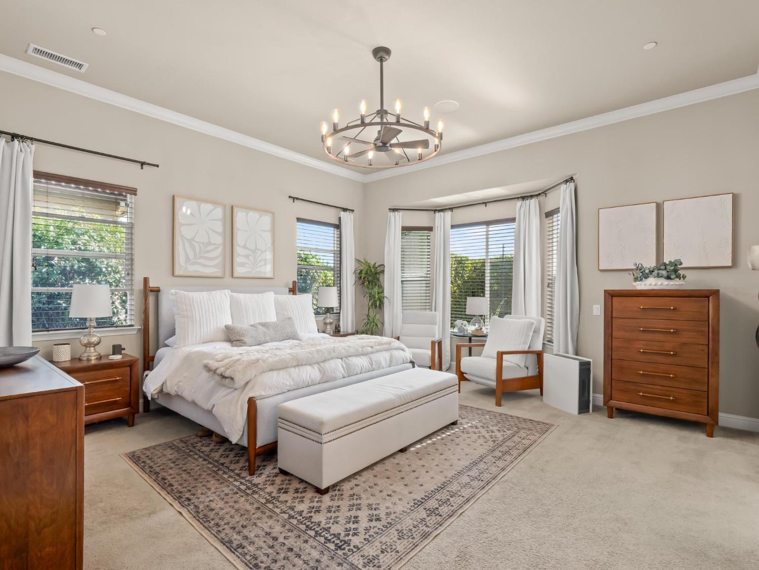 2750 Muncie Avenue Clovis, CA 93619 - Photo 22 of 51 a bedroom with a large bed and a chandelier