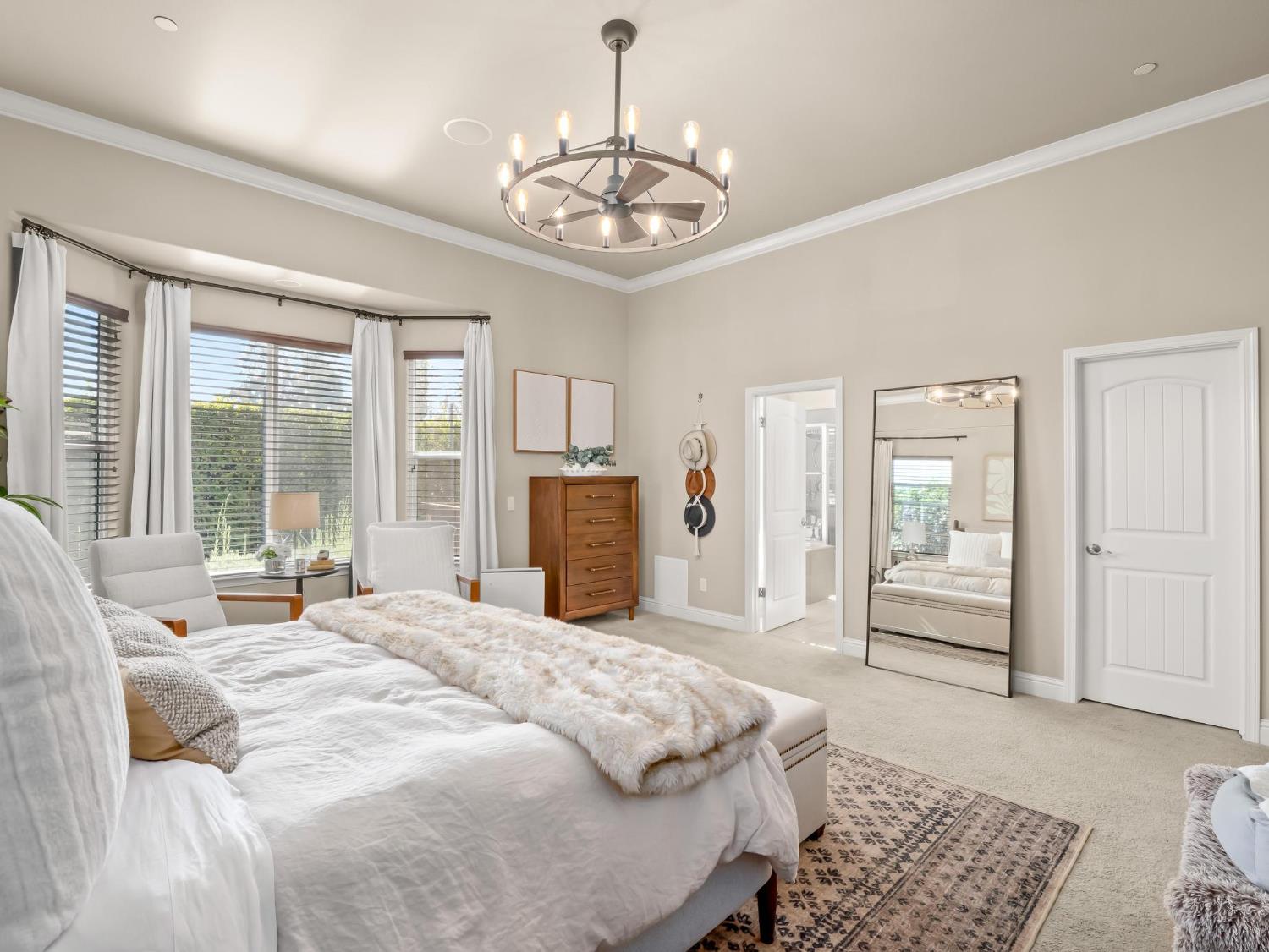 2750 Muncie Avenue Clovis, CA 93619 - Photo 24 of 51 a bedroom with a large bed and a chandelier