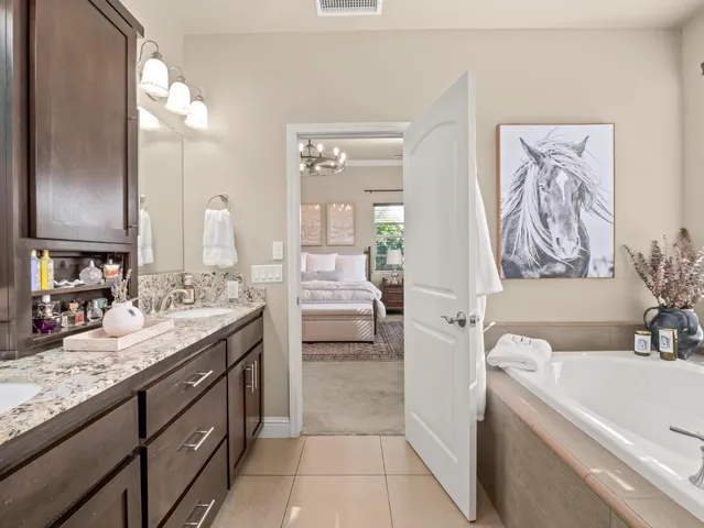 a dining room with furniture potted plants and wooden floor