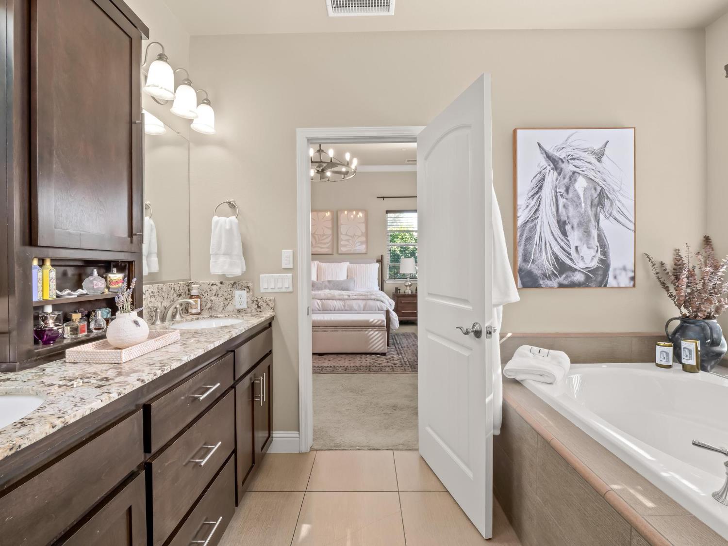 2750 Muncie Avenue Clovis, CA 93619 - Photo 29 of 51 a bathroom with a granite countertop sink a toilet a mirror and bathtub