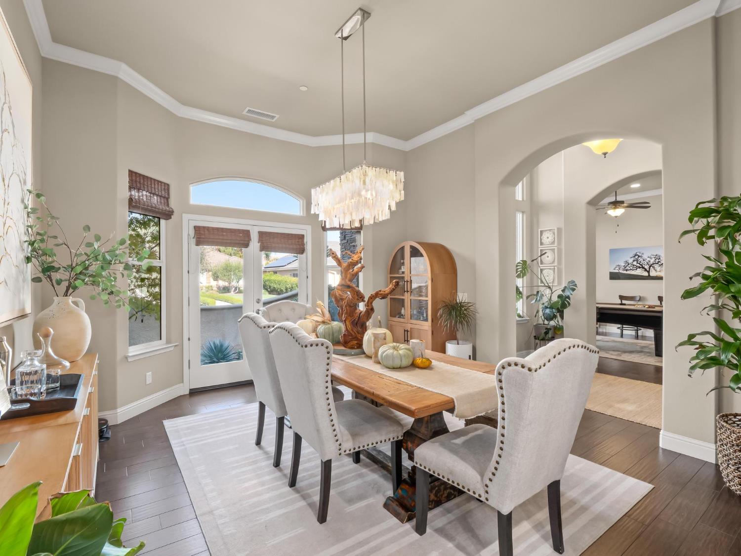 2750 Muncie Avenue Clovis, CA 93619 - Photo 30 of 51 a dining room with furniture potted plants and wooden floor