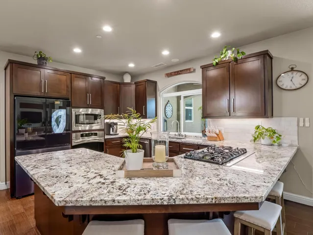 a kitchen with lots of counter top space sink and large window