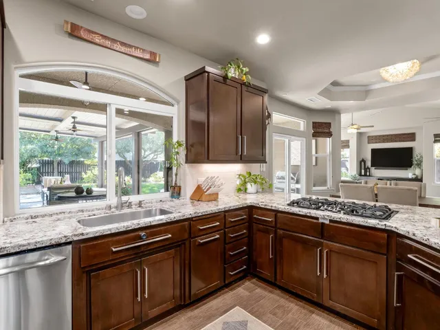 a kitchen with granite countertop stainless steel appliances and counter space