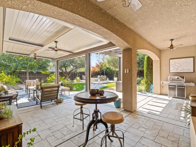 a view of a patio with couches chairs and a potted plant