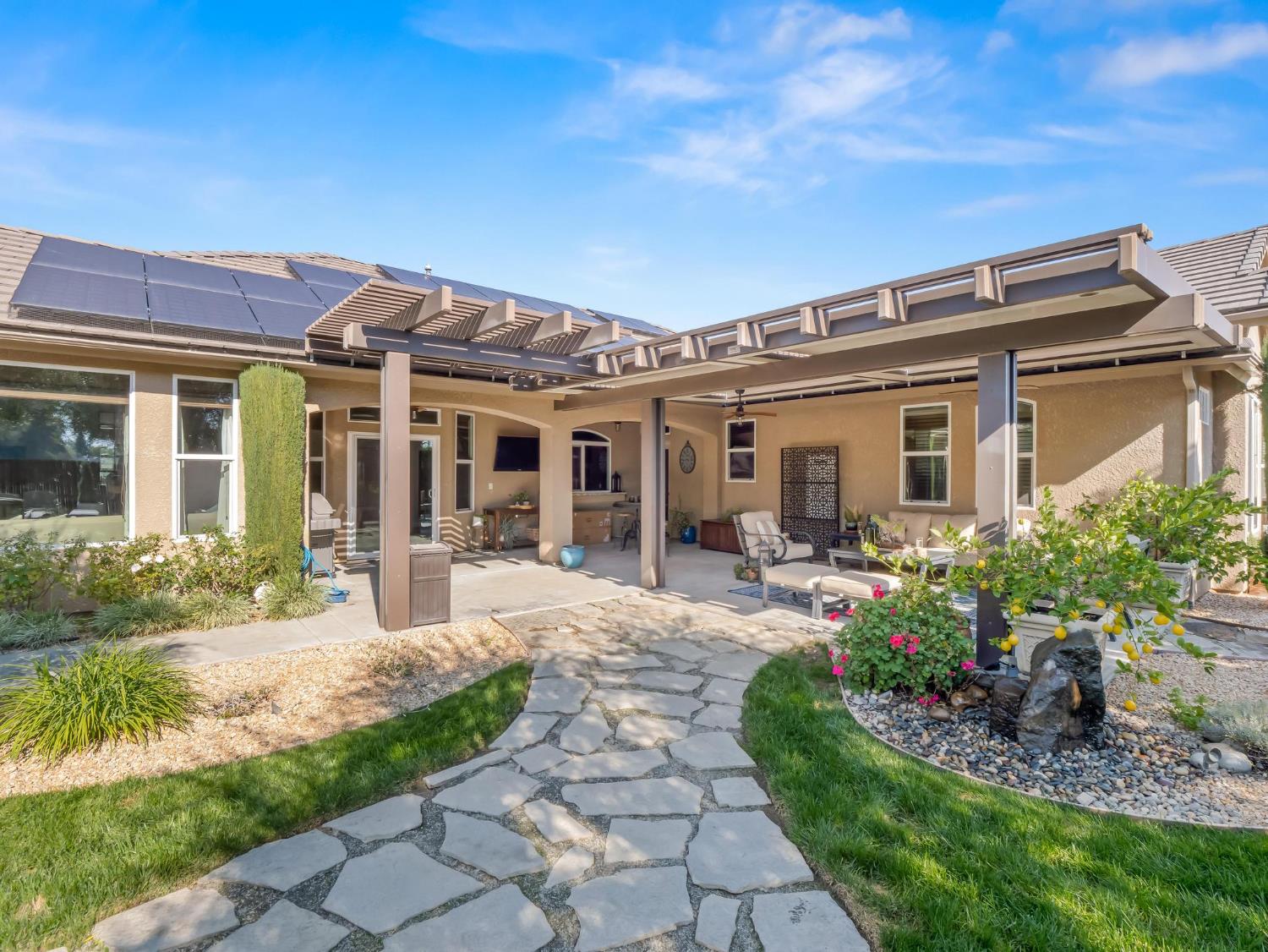 2750 Muncie Avenue Clovis, CA 93619 - Photo 43 of 51 a view of a house with backyard sitting area and garden