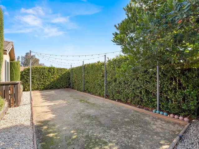 a view of a house with a small yard and plants