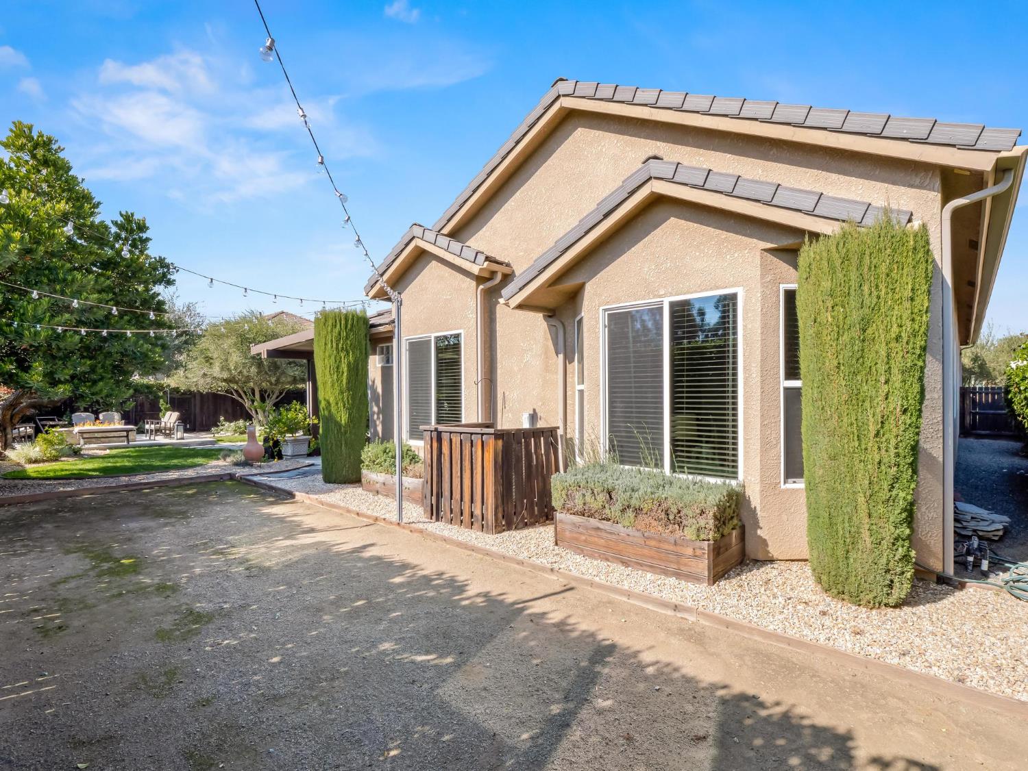 2750 Muncie Avenue Clovis, CA 93619 - Photo 47 of 51 a view of a house with a small yard and plants