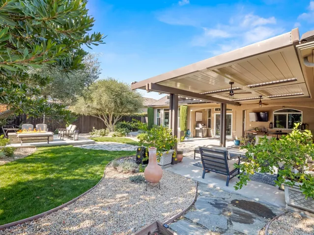 a swimming pool with outdoor seating and yard