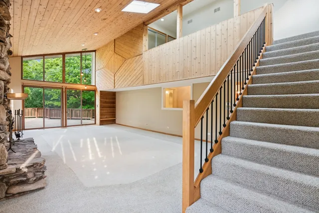 a kitchen with stainless steel appliances granite countertop a stove top oven a sink dishwasher and a refrigerator with wooden cabinets