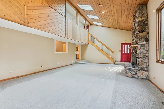 a kitchen with stainless steel appliances granite countertop a refrigerator a stove and a sink