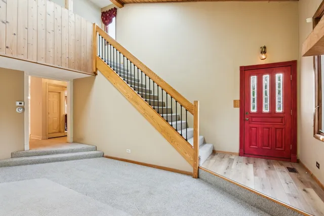 a view of an empty room with a fireplace and windows
