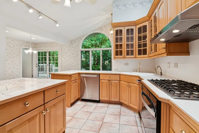an empty room with a window and a ceiling fan