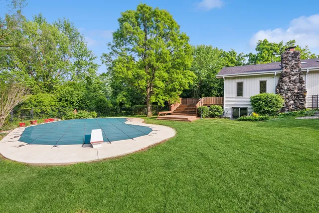 a view of a backyard with swimming pool