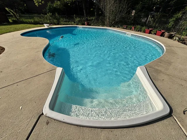 a living room with furniture a fireplace and a floor to ceiling window