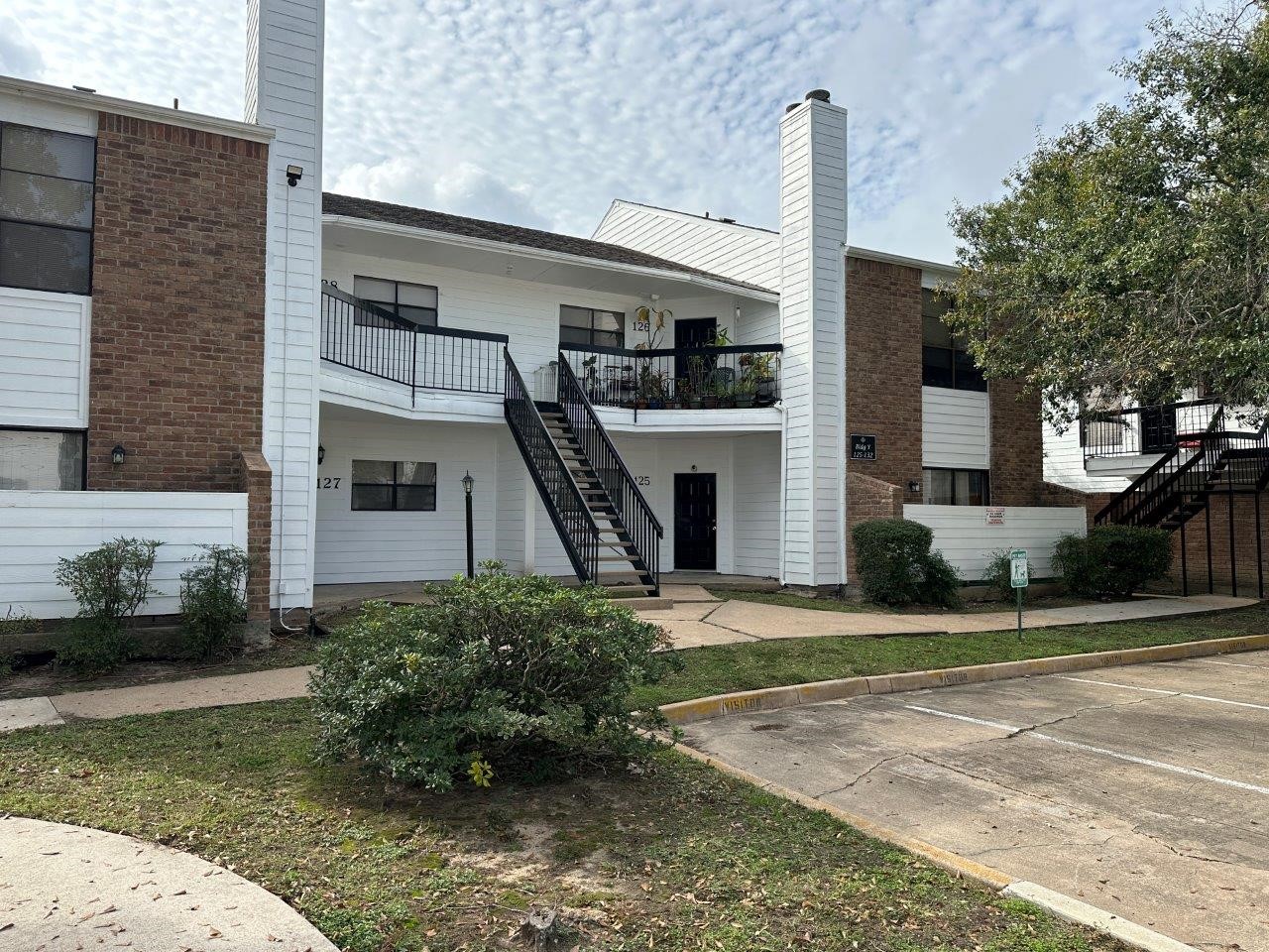 7901 Cambridge Street, Unit 104 Houston, TX 77054 - Photo 13 of 15 a front view of a house with a yard