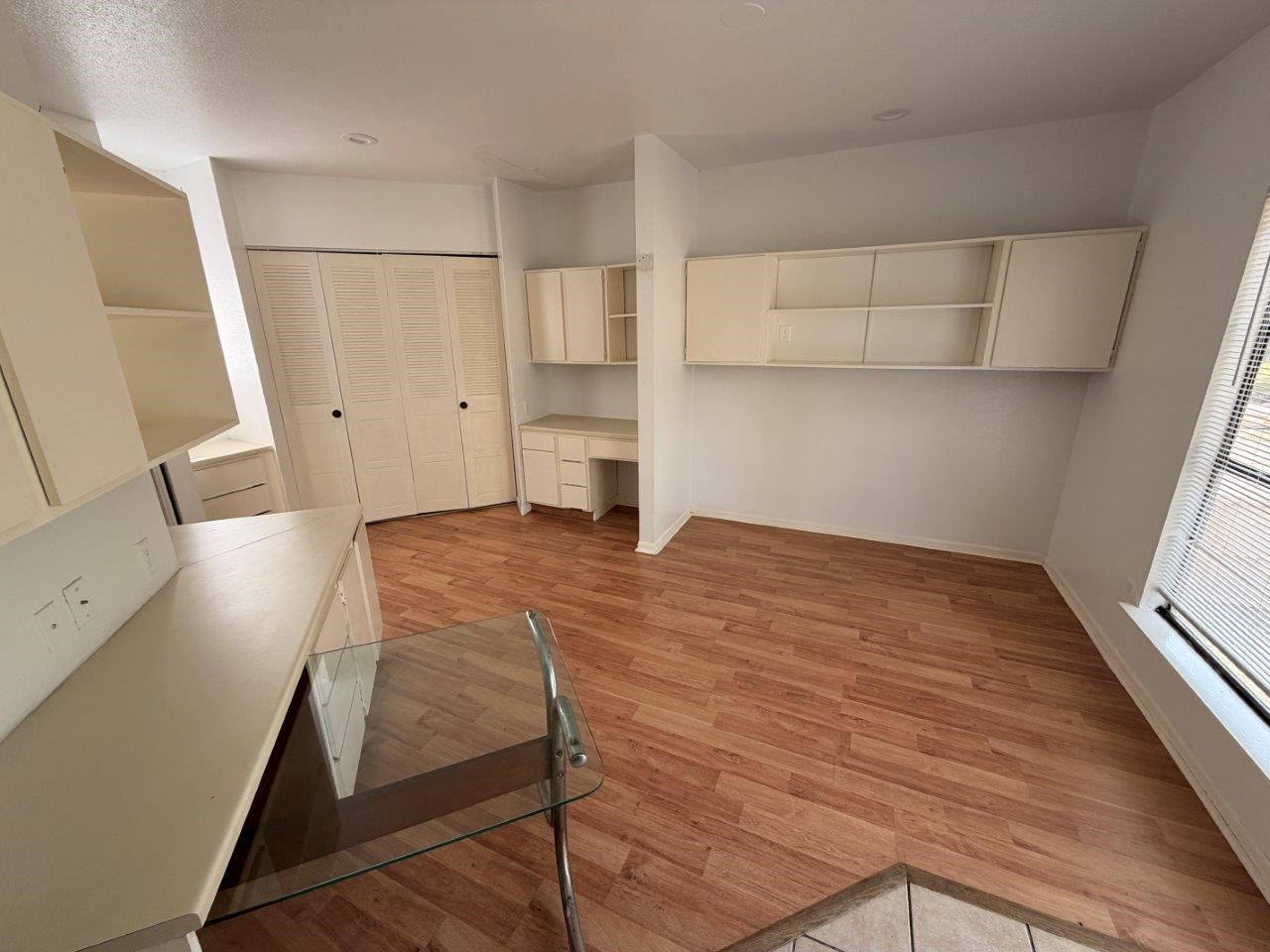 7901 Cambridge Street, Unit 104 Houston, TX 77054 - Photo 5 of 15 a room with wooden floor and white walls