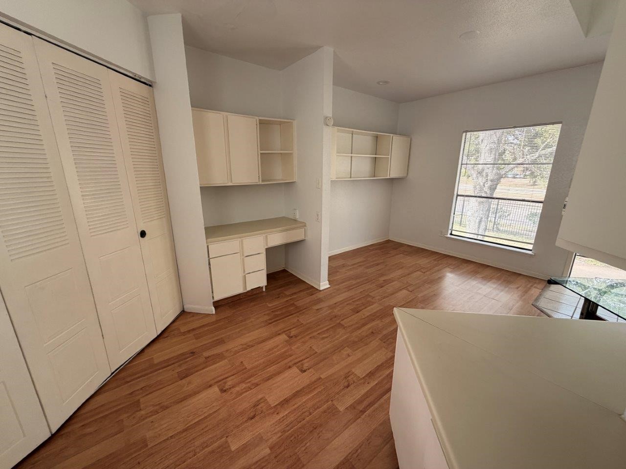 7901 Cambridge Street, Unit 104 Houston, TX 77054 - Photo 7 of 15 a view of empty room with wooden floor and fan