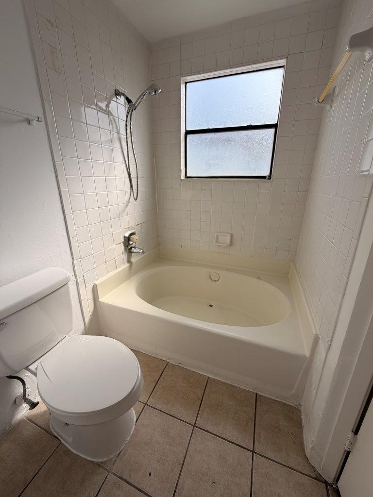 7901 Cambridge Street, Unit 104 Houston, TX 77054 - Photo 8 of 15 a white toilet sitting next to a bath tub