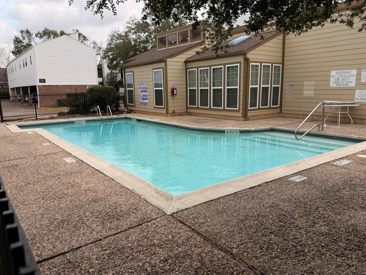 7901 Cambridge Street, Unit 104 Houston, TX 77054 - Photo 10 of 15 a view of a house with pool and chairs