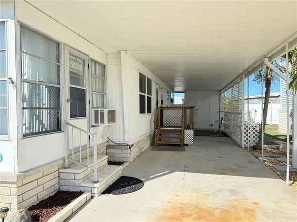 a view of a house with wooden floor and outdoor seating
