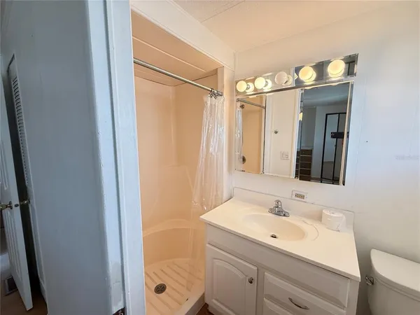 a bathroom with a sink a mirror and a shower