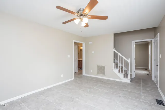 a view of an empty room with a ceiling fan