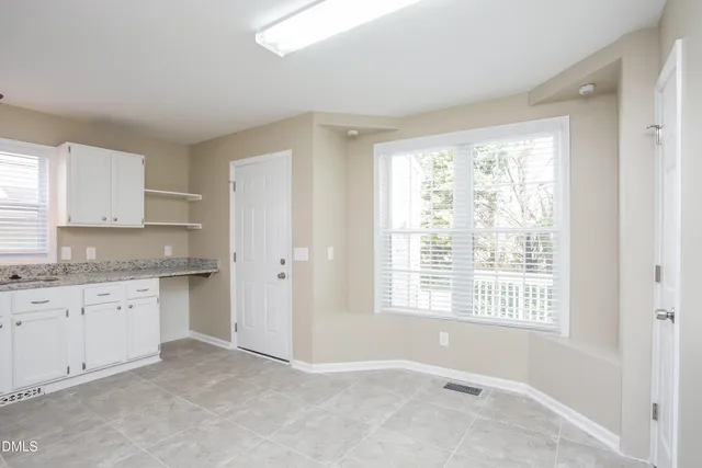 a big room with granite countertop cabinets and a sink