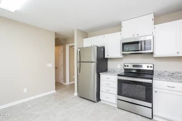 a kitchen with a refrigerator sink and stove top oven
