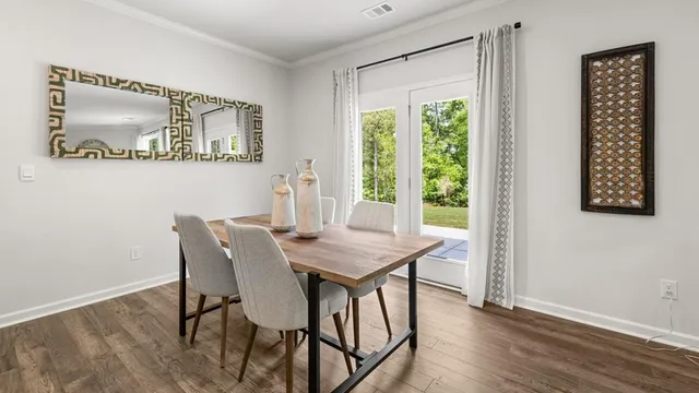 a view of a dining room with furniture window and wooden floor