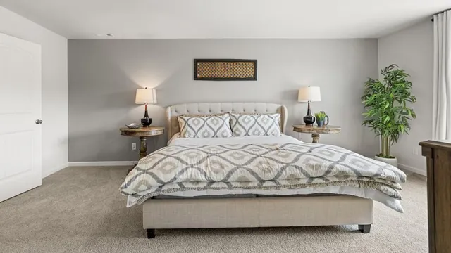 a bedroom with a bed and a potted plant