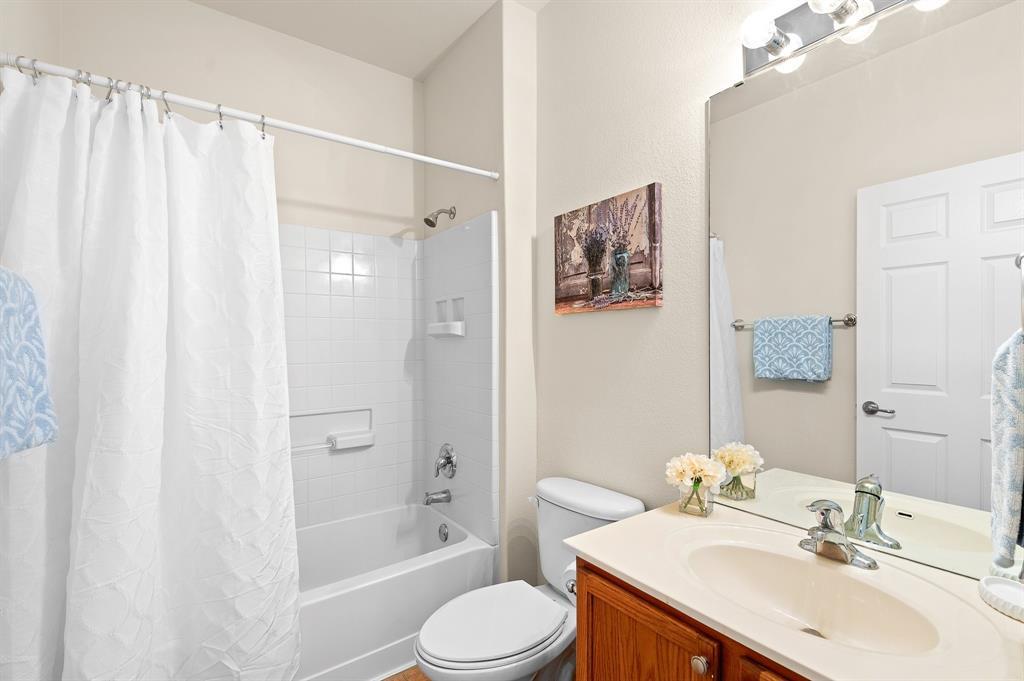 109 Providence Street Georgetown, TX 78633 - Photo 25 of 31 Bathroom featuring a vanity with a light-colored countertop and integrated sink, chrome faucet, and a large mirror