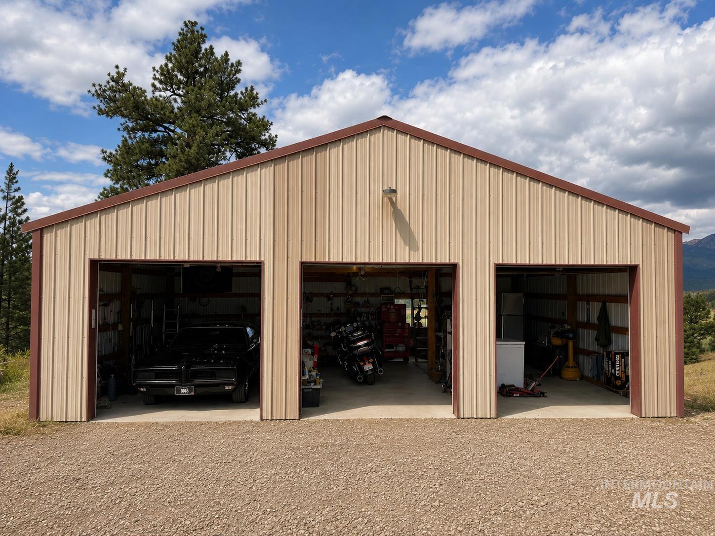 40 Atkin Lane Cascade, ID 83611 - Photo 2 of 46 Spacious interior with high wood-plank ceilings, a prominent wood-burning stove on a brick hearth, and a two-story exposed wood staircase leading to an upper loft