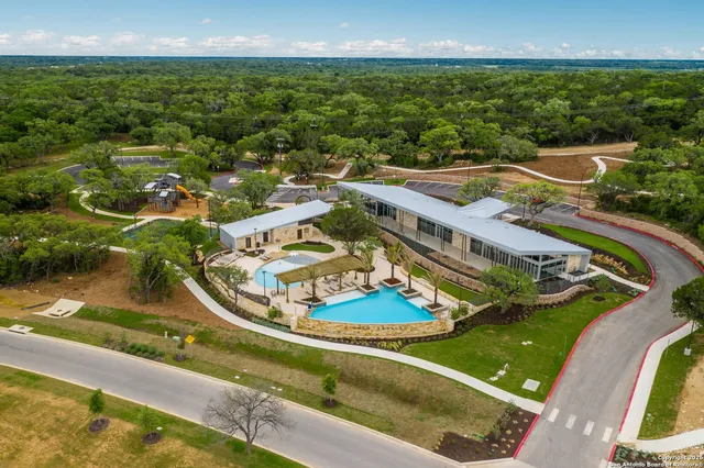 a view of a house with swimming pool and porch with furniture