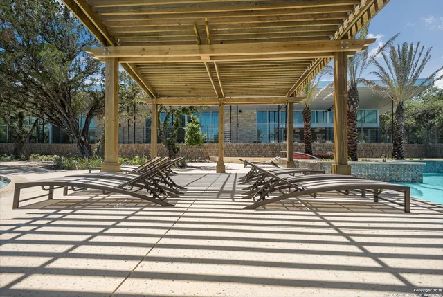 a view of swimming pool with outdoor seating and water view