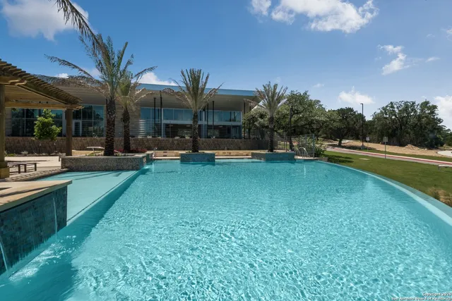 a view of a swimming pool and lounge chair