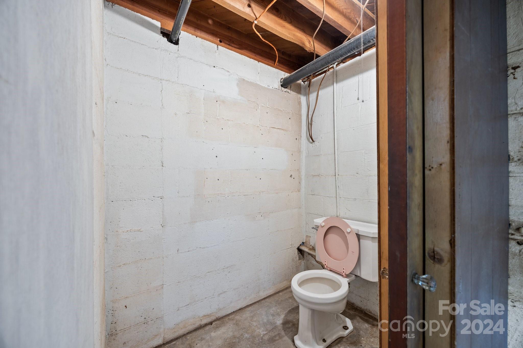 105 Hilltop Farm Road Canton, NC 28716 - Photo 34 of 48 a bathroom with a granite countertop toilet and a shower